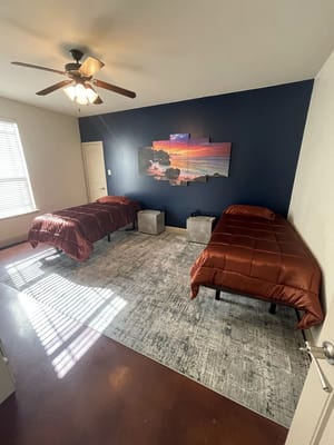 A comfortable shared bedroom with two beds and a modern decor.