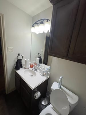 A well-lit bathroom with a sink and toilet