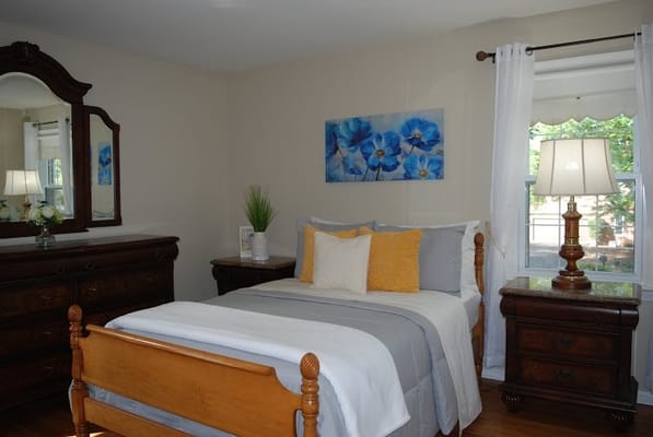 Cozy resident bedroom with floral decor and furniture