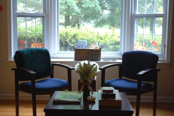 Cozy seating area next to a window with plants outside