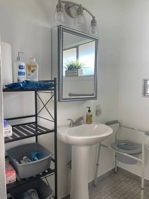 Accessible bathroom with sink and shelves