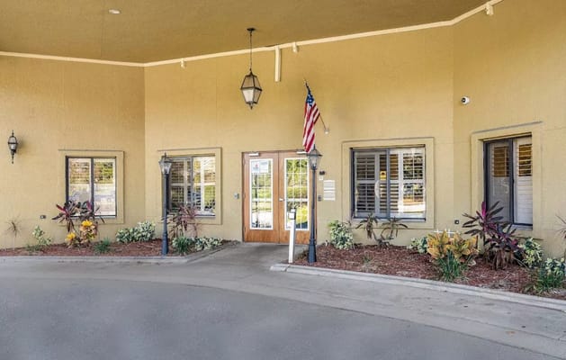 The entrance of Indian River Center with plants and an American flag