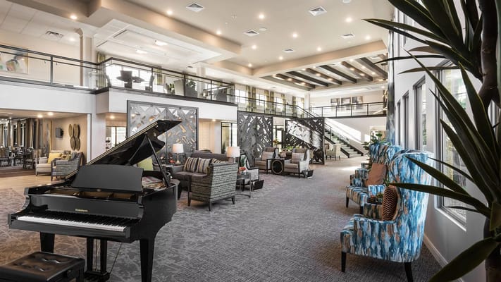 Spacious and stylish common area with a piano