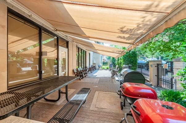 Outdoor patio area with grill and seating