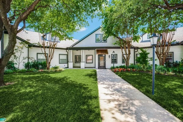 Front entrance of a senior living facility with landscaping