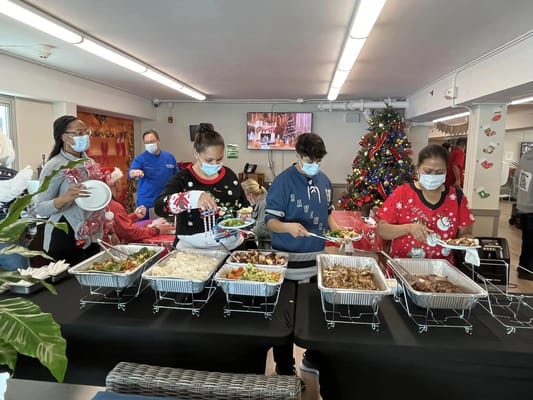 Residents and staff enjoying a meal together during a celebration