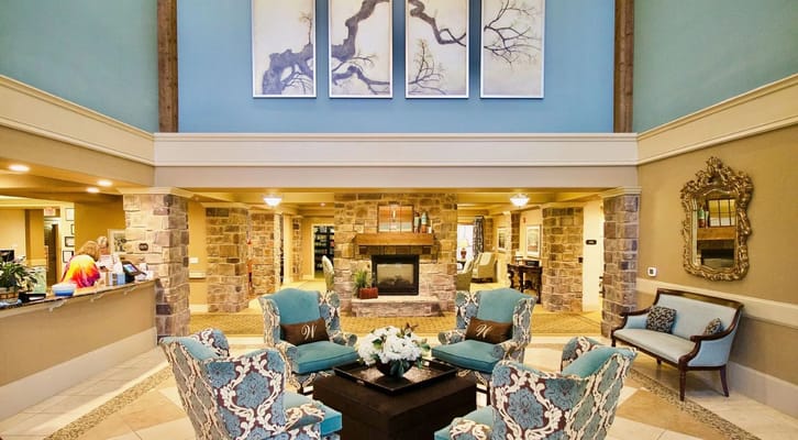 Lobby area with a fireplace and seating at Isle at Watercrest Mansfield.