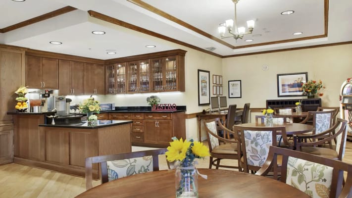 Bright dining area with wooden tables and floral decor
