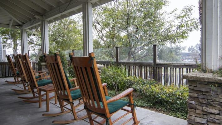 Porch with rocking chairs overlooking greenery