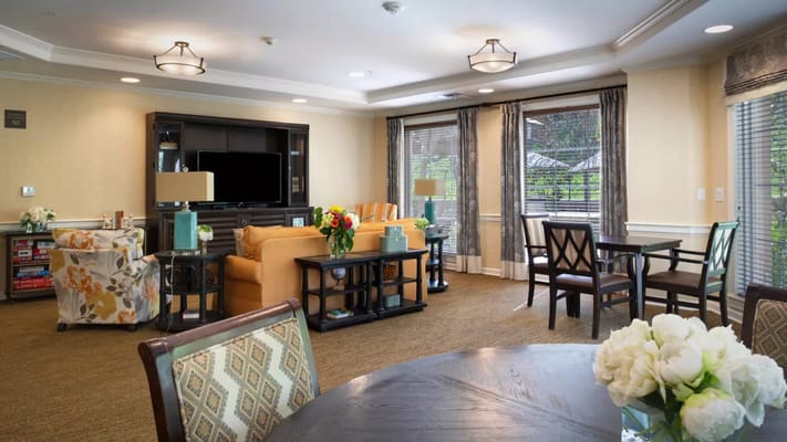 Bright common area with seating and floral arrangements