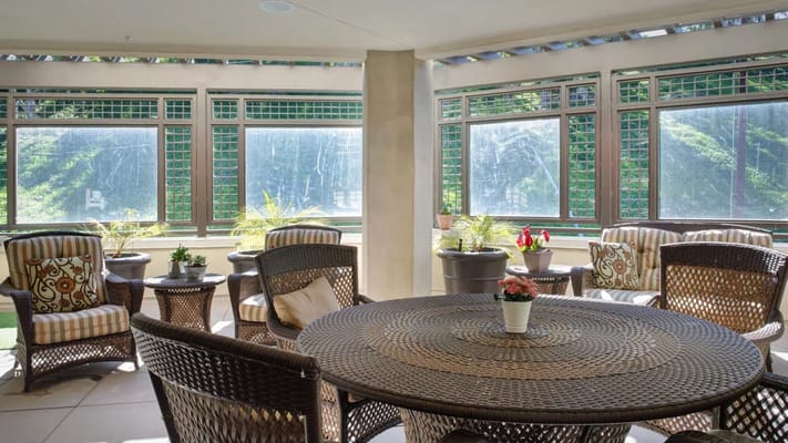 Interior sunroom with wicker furniture and plants