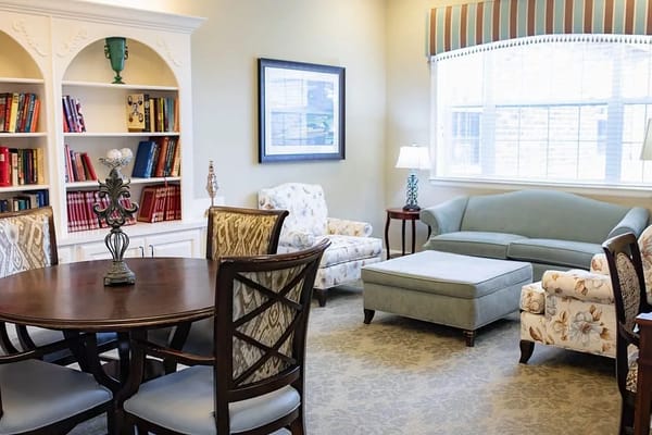 Cozy common area with seating and bookshelf