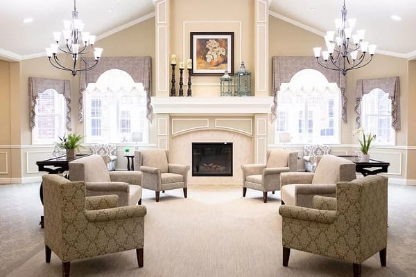 Well-decorated common area with seating and natural light