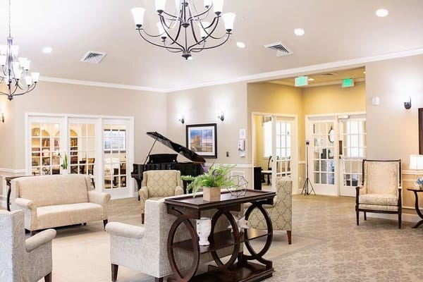 Bright common area with seating and a piano
