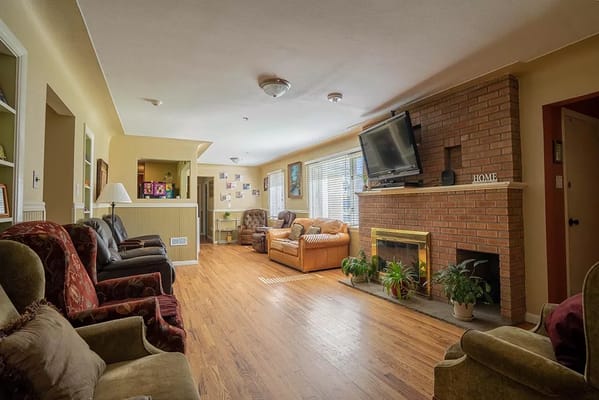 Spacious living room with comfortable seating and a fireplace.
