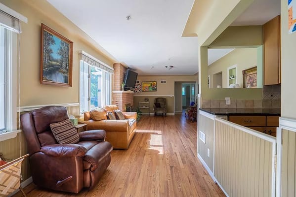 Bright living room with comfortable seating and a large window.