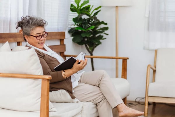 A resident reading a book in a cozy living area