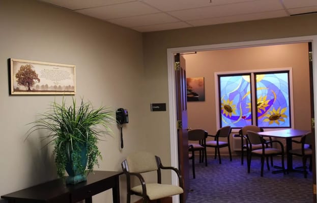 Interior view of a common area with a stained glass window