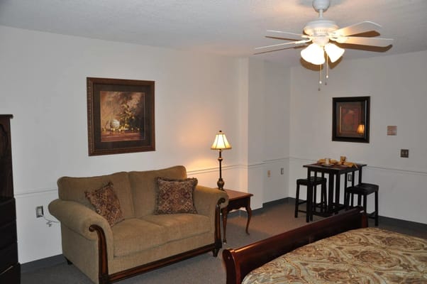 Cozy private room with a couch and lamp