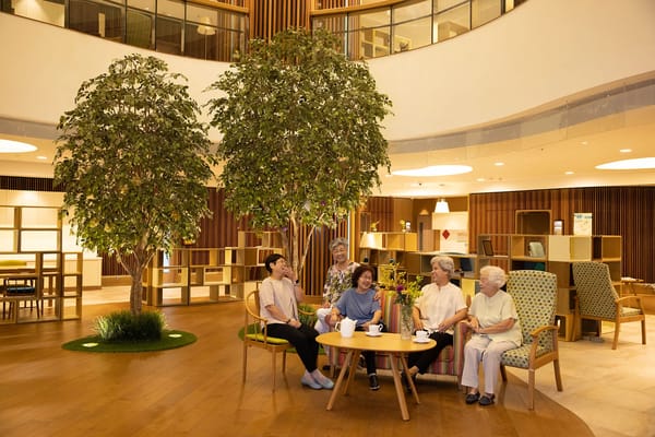 Residents enjoying coffee in a bright common area