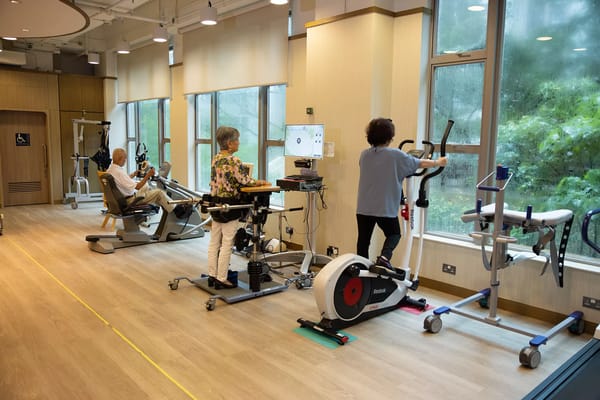 Residents participating in exercise activities in a gym area