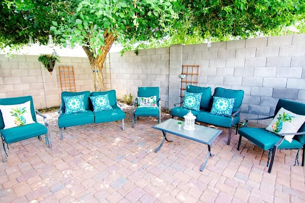 Outdoor seating area under a shaded tree