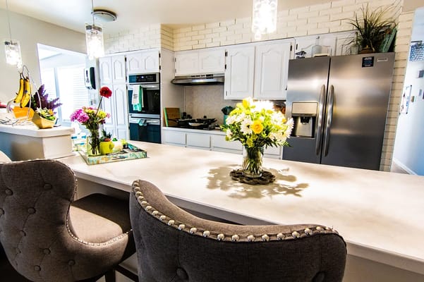 Bright kitchen area with flowers and modern decor