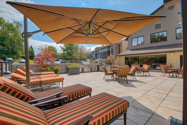 Outdoor seating area with lounge chairs and patio umbrellas