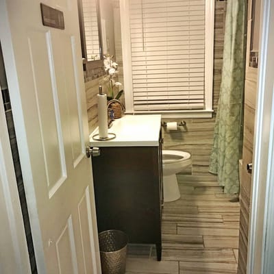 Modern bathroom with a shower, sink, and toilet