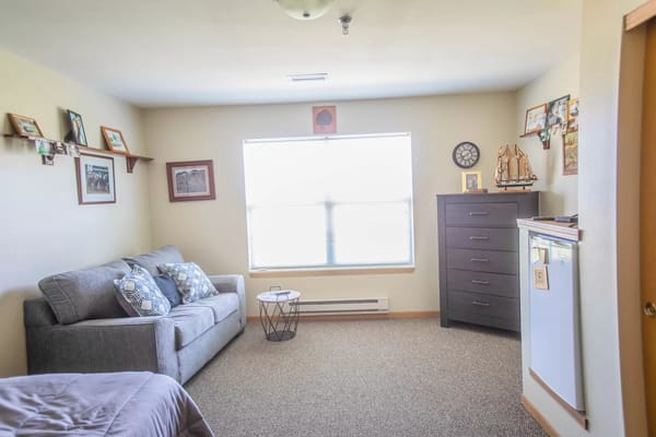 Cozy private resident room with a sofa and decor