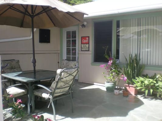 Outdoor patio area with seating and flowers