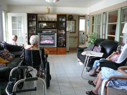 Residents enjoying television in a common area lounge