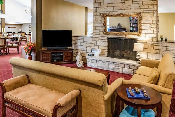 Living room area with a sofa, TV, and fireplace