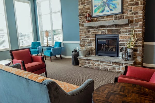 Bright common area with comfortable seating and fireplace