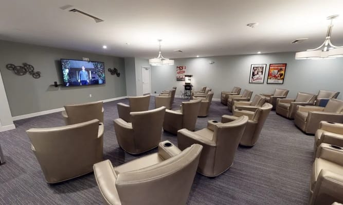 Comfortable seating in the theater room with a large screen.