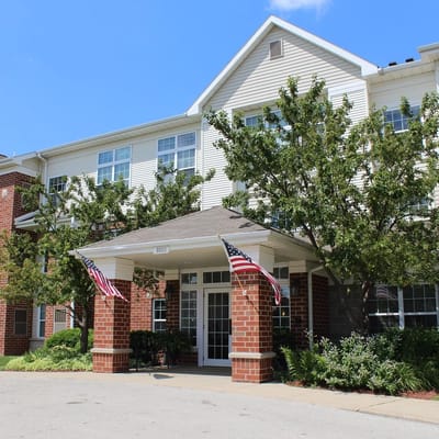 Exterior view of Killarney Kourt entrance with flags