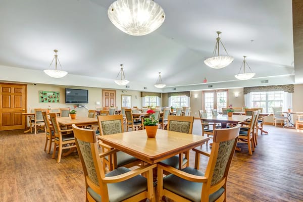 Interior view of a bright common area with tables and chairs