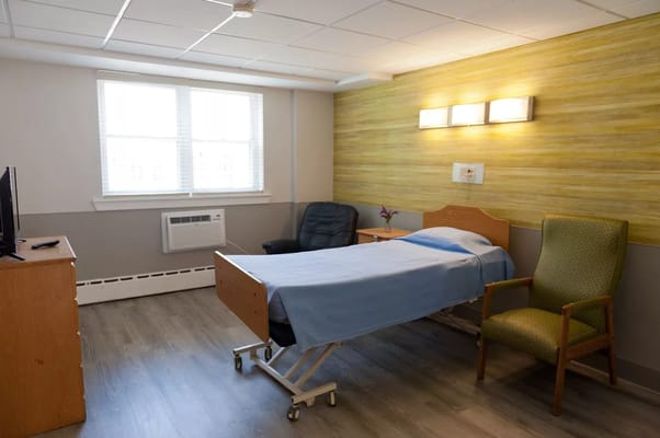 A single resident room with a bed and seating