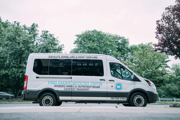 Facility transport van parked near greenery