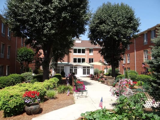 Outdoor courtyard with benches and flower beds