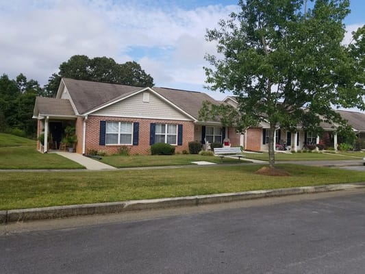View of Kirkwood Trails Senior Apartments with green lawn and pathway
