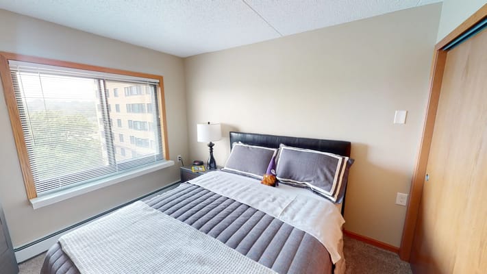 Cozy bedroom with a window and a bed