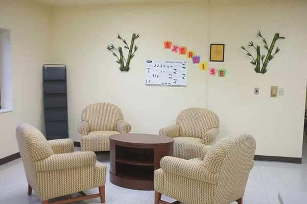 Common area with chairs and exercise poster