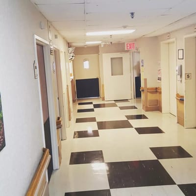 Empty hallway with black and white tiled floor