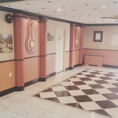 Interior of Laconia Nursing Home featuring a patterned floor and decorative walls.