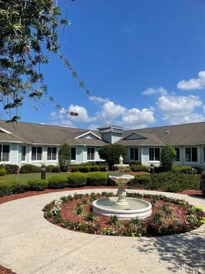Exterior view of Lady Lake Senior Living with fountain and landscaping