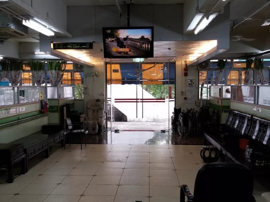 A view of the lobby area with seating and a television display.