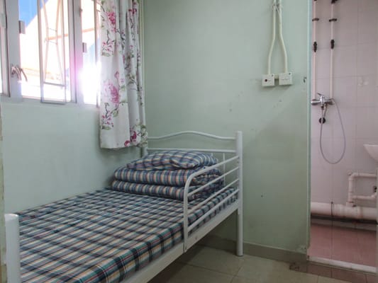 Cozy bedroom with a single bed and floral curtains.