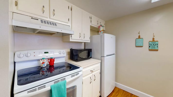 Bright kitchen area with appliances and decor