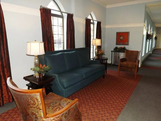 Cozy common area with seating in a well-lit hallway